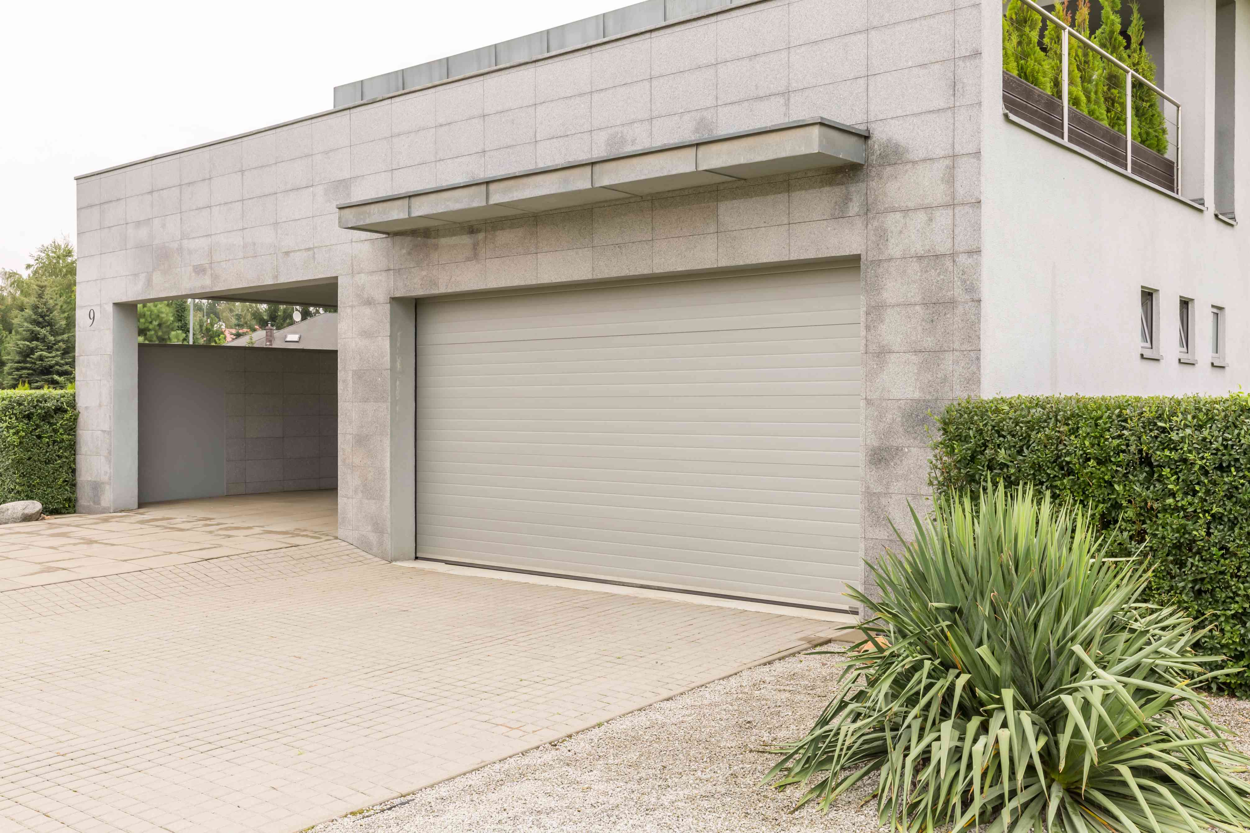 garage-in-big-house-PZYTQ4R(1) How do I hire a commercial door repair professional | Automated Door Systems